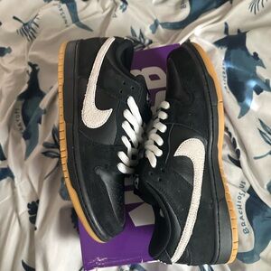 Nike Black Low-Top Sneakers with White Swoosh and Gum Sole